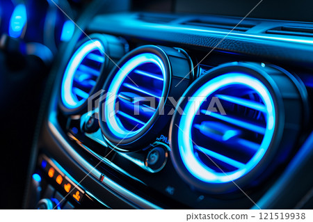 Detailed close-up of abstract illuminated car air conditioning vents with blue accents 121519938