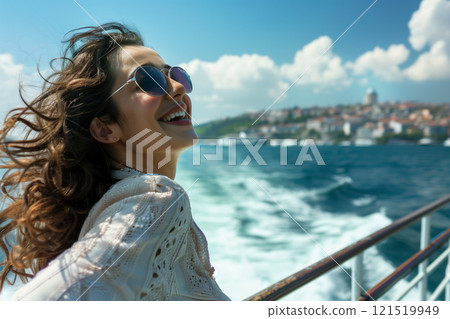 Joyful woman smiling and enjoying the scenic view of the sea on a ferry boat crossing the bosphorus Joyful woman smiling and enjoying the scenic view of the sea on a ferry boat crossing the bosphorus 121519949