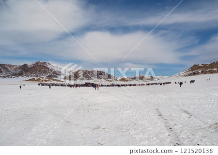 More tourists on a snowy slope to distance. More tourists on a snowy slope to distance. 121520138