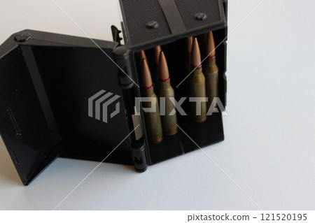 Standard 5.45 ammo in ammo storage box on white surface Standard 5.45 ammo in ammo storage box on white surface 121520195