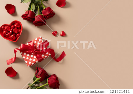Valentine's day card with gift, hearts and red roses on beige background. View from above. Copy space. Romantic date concept. Greeting card. 121521411