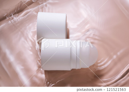 Roll-on deodorant on a pink background in water. Roll-on deodorant on a pink background in water. 121521563