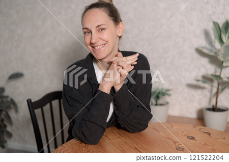 peace woman emotion happy sitting comfortably on a gray couch at home, smiling and relaxing in soft natural light during the afternoon peace woman emotion happy sitting comfortably on a gray couch at home, smiling and relaxing in soft natural light during the afternoon 121522204