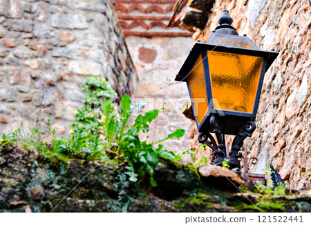 Photo centered on the charm of the lampposts forged in the town of Pals de Girona Photo centered on the charm of the lampposts forged in the town of Pals de Girona 121522441