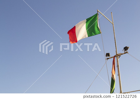 Italy Flag waving against clean blue sky Italy Flag waving against clean blue sky 121522726