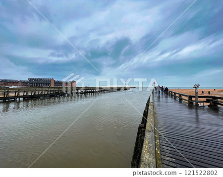 Wooden jetty on the Etretat, in the Normandy, France with gloomy cloudy rainy sky and clouds. 121522802