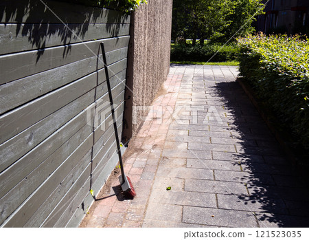 Broom on clean street, outdoors cleaning. City cleaning service. 121523035