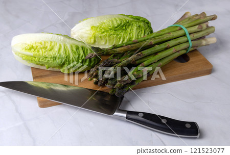 Fresh vegetables on the kitchen table cabbage, salad, asparagus. 121523077