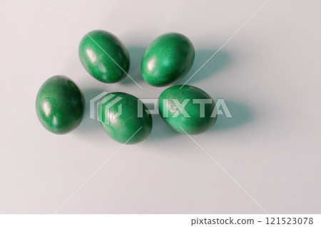 Traditional green easter eggs. Chicken eggs are painted red Traditional green easter eggs. Chicken eggs are painted red 121523078
