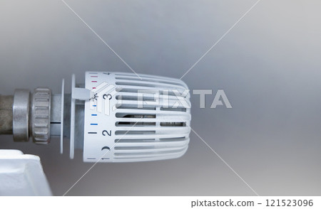 Heating battery temperature regulation in house with thermostat on white radiator. 121523096