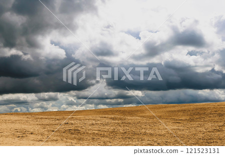Beautiful background of dramatic sky with clouds and yellow sand. 121523131
