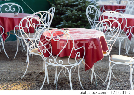 Cozy street cafe with empty tables on a sunny day. 121523162