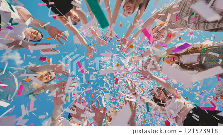 Joyful high school students toss colorful confetti in the air to celebrate their summer graduation Joyful high school students toss colorful confetti in the air to celebrate their summer graduation 121523918