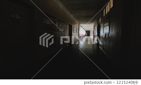 Dimly lit school hallway after the last school day, evoking a sense of nostalgia, memories, and the passage of time Dimly lit school hallway after the last school day, evoking a sense of nostalgia, memories, and the passage of time 121524069