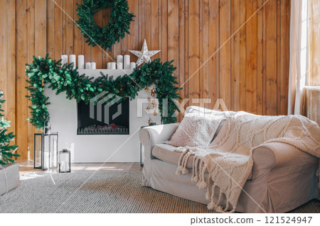 Living room with white sofa and fireplace decorated for Christmas and New year holidays 121524947