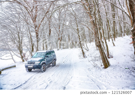 Fabulous veiw of empty road with snow covered landscape while snowing in winter season 121526007