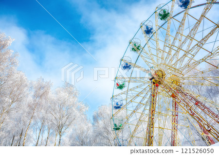 Amazing view of snow covered ferris wheel surrounded by snowcovered trees. 121526050