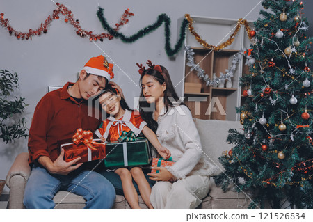 Father, mother and child celebrating Christmas. Father, mother and child celebrating Christmas. 121526834