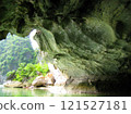 Light shining into a rock cave in Halong Bay, Vietnam 121527181