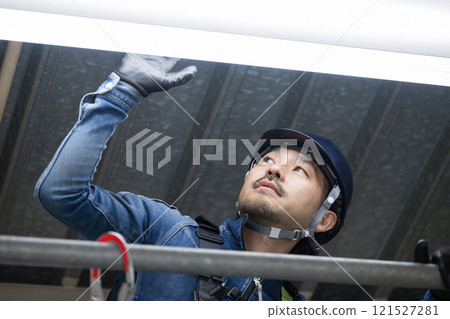 Electricians and workers at height wearing denim while carrying out electrical inspection work 121527281