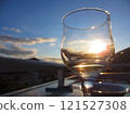 The light of the sunset shines through the wine glass 121527308