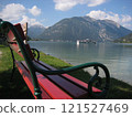 Red bench overlooking a lake in Austria 121527469