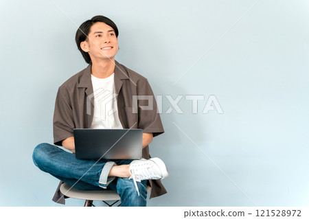 Young Asian man using a computer, notebook, pc, laptop (talking, conversation) Young Asian man using a computer, notebook, pc, laptop (talking, conversation) 121528972