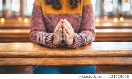 Hands in Prayer at a Quiet Place of Worship 121529096
