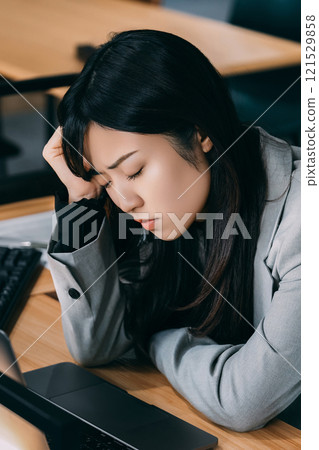 A woman/businesswoman holding her head in frustration A woman/businesswoman holding her head in frustration 121529858