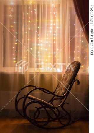 A rocking chair by the window A rocking chair by the window 121531893