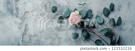 A stylish arrangement of roses and eucalyptus leaves rests elegantly against a textured concrete background, creating a modern aesthetic. Generative AI 121532216