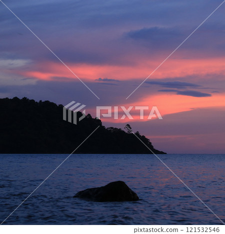 Bright pink lit clouds seen from  Lonely Beach, Koh Chang, Thailand. 121532546