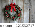 Red Bow Christmas Wreath on Rustic Wood 121532717