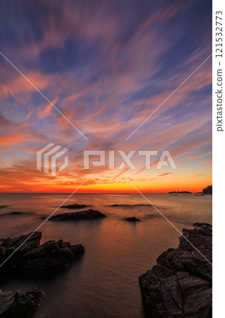 Sunset over the coastline Sunset over the coastline 121532773