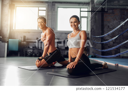 Fitness Enthusiasts Practicing Yoga in a Modern Gym Setting to Enhance Their Wellbeing Fitness Enthusiasts Practicing Yoga in a Modern Gym Setting to Enhance Their Wellbeing 121534177