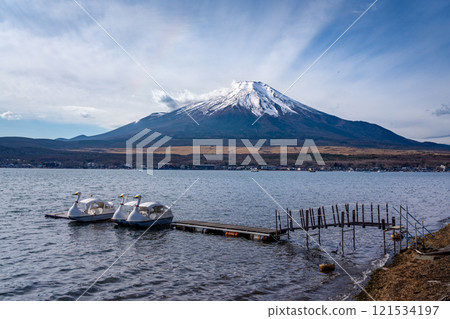 View of mount Fuji with background clouds and paddle swan boats at lake Kawaguchiko in foreground View of mount Fuji with background clouds and paddle swan boats at lake Kawaguchiko in foreground 121534197