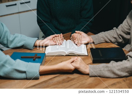 Christians are congregants join hands to pray and seek the blessings of God. 121534550