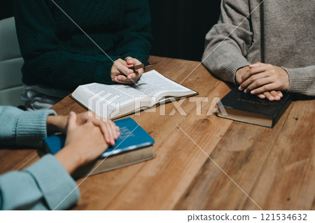 People reading and study bible in home and pray together.Studying the Word Of God 121534632