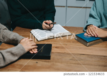 People reading and study bible in home and pray together.Studying the Word Of God 121534633