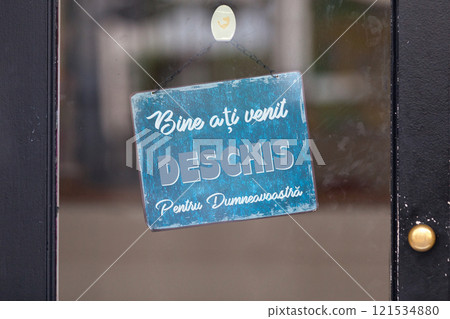 Open sign written in Romanian 121534880