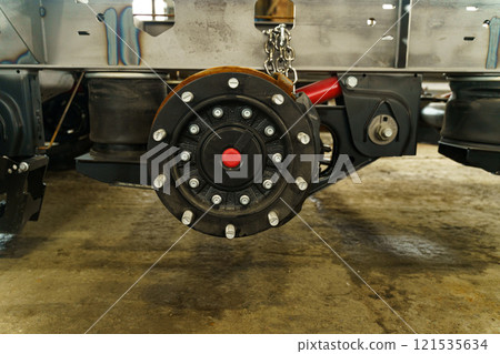 Detail of a heavy-duty suspension system on a commercial vehicle in a workshop 121535634
