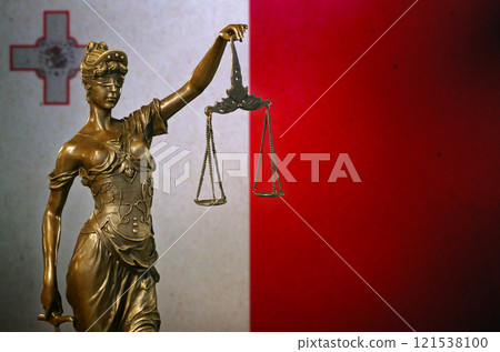 Lady Justice before a flag of Malta 121538100
