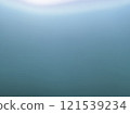 A photo of the surface of water with light shining from above - Gradient 121539234