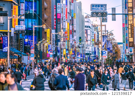 Tokyo cityscape in Japan: Towards a new era... Pedestrian mall at the east exit of Shinjuku Station at the end of the year. Threatening flow of people... A ray of hope... = 29th 121539817