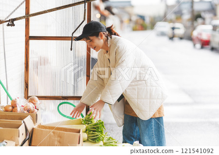 A young female sales clerk arranging products at a traditional fruit and vegetable store. (Photo courtesy of Nuttari Terrace Shopping Arcade) A young female sales clerk arranging products at a traditional fruit and vegetable store. (Photo courtesy of Nuttari Terrace Shopping Arcade) 121541092