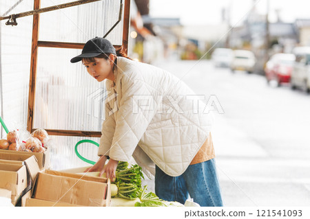 A young female sales clerk arranging products at a traditional fruit and vegetable store. (Photo courtesy of Nuttari Terrace Shopping Arcade) A young female sales clerk arranging products at a traditional fruit and vegetable store. (Photo courtesy of Nuttari Terrace Shopping Arcade) 121541093