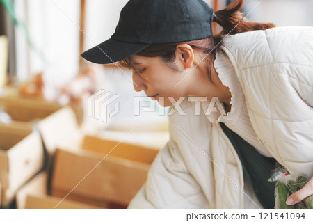 A young female sales clerk arranging products at a traditional fruit and vegetable store. (Photo courtesy of Nuttari Terrace Shopping Arcade) A young female sales clerk arranging products at a traditional fruit and vegetable store. (Photo courtesy of Nuttari Terrace Shopping Arcade) 121541094