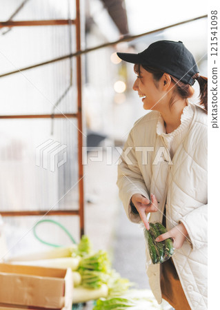 A young female sales clerk arranging products at a traditional fruit and vegetable store. (Photo courtesy of Nuttari Terrace Shopping Arcade) A young female sales clerk arranging products at a traditional fruit and vegetable store. (Photo courtesy of Nuttari Terrace Shopping Arcade) 121541098