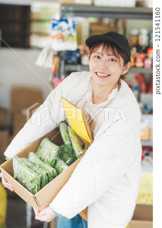 Portrait of a young female sales clerk working at a traditional fruit and vegetable store [Photo courtesy of Nuttari Terrace Shopping Arcade] 121541160