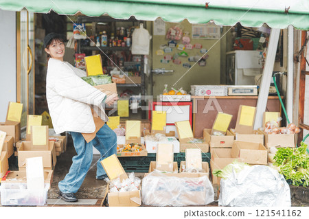 Portrait of a young female sales clerk working at a traditional fruit and vegetable store [Photo courtesy of Nuttari Terrace Shopping Arcade] 121541162